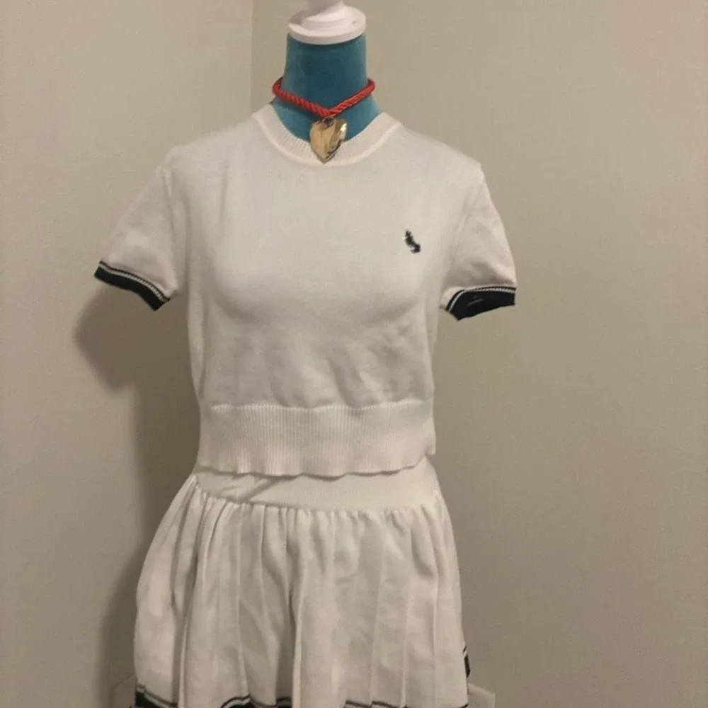 White‎ polo shirt with navy blue stripes and embroidered logo